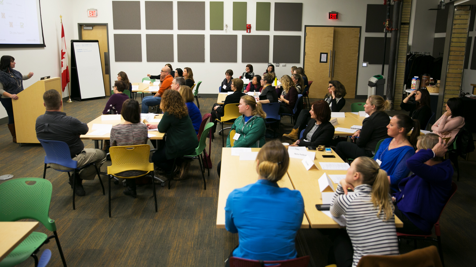 A group of people are sitting down while watching a presentation.