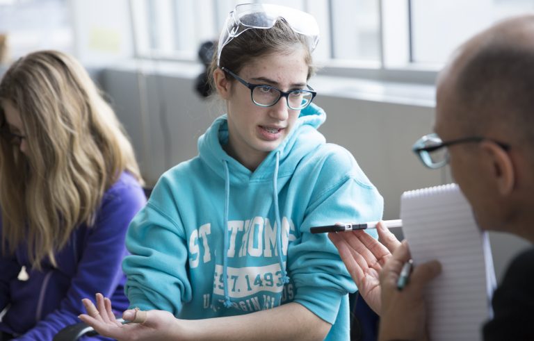 Rebels team member, Madeline McDonnell, discussing with another team member