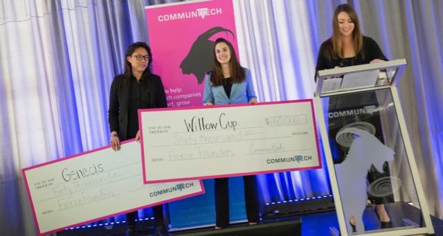 The top two winners of the Fierce Founders pitch competition posing onstage with oversized cheques