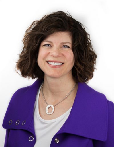 A person smiling in front of a white background.