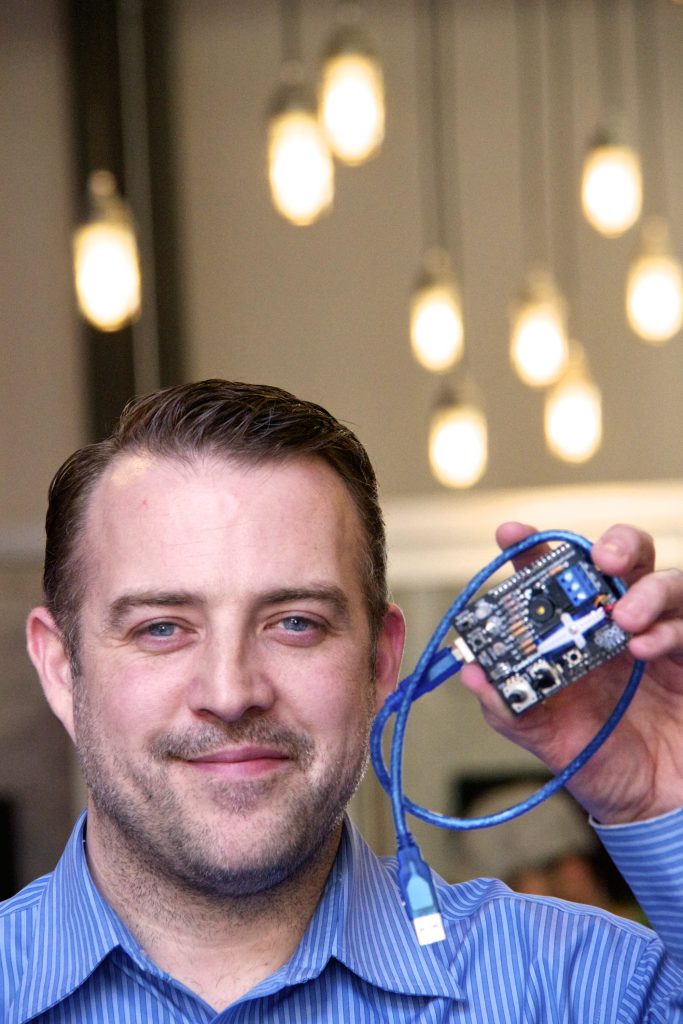 Ian Pilon holding a computerchip