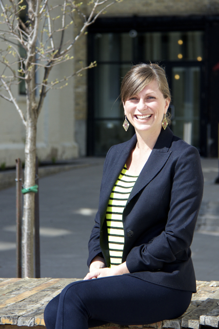 Jennifer Moss of Plasticity Labs sitting on a stone bench