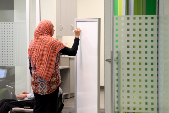 Person writing on whiteboard