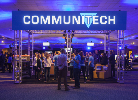 Attendees mingling under a Communitech sign