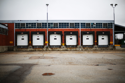 6 loading bay doors attached to a warehouse.