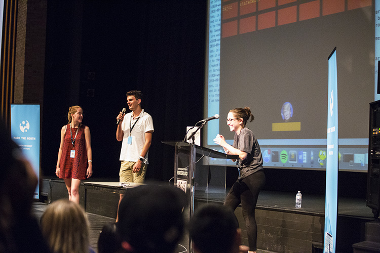 Three people giving a presentation on stage